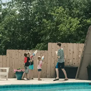 Kids with water guns shooting bubbles